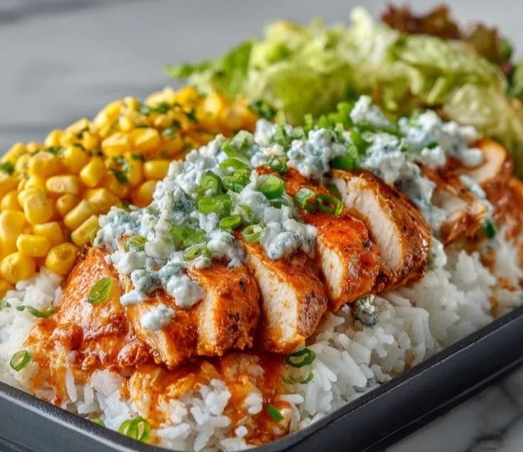 Buffalo Chicken Protein Bowl garnished with fresh vegetables and dressing