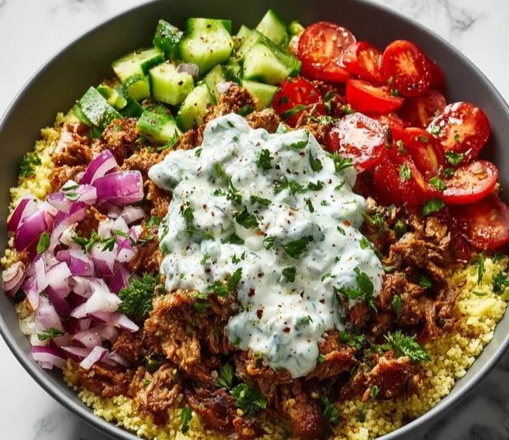 Ground turkey gyro bowl with fresh vegetables and tzatziki sauce