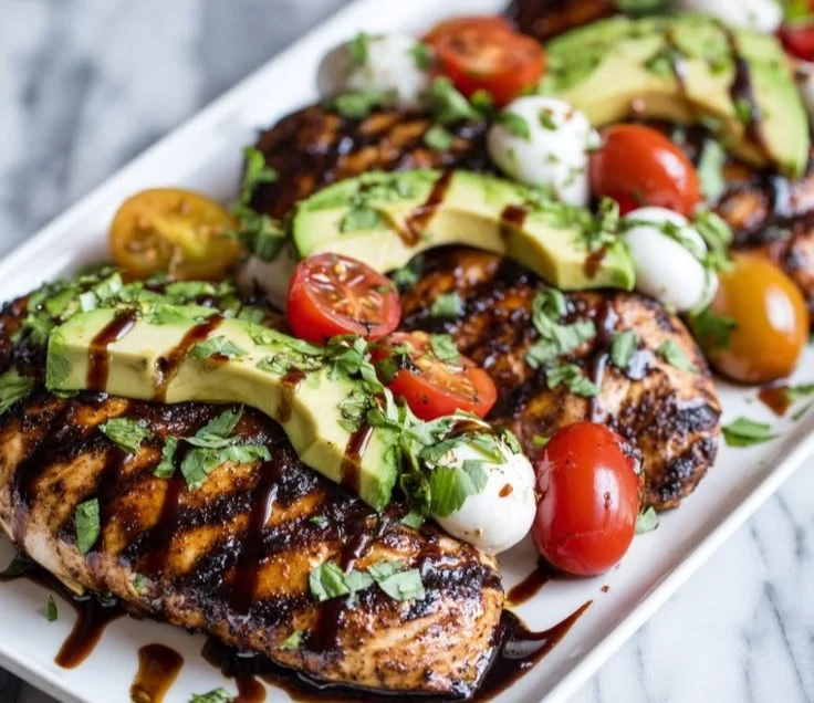 Juicy grilled chicken topped with fresh California avocado on a plate
