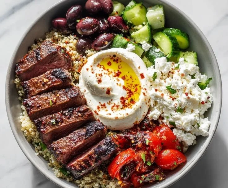 Mediterranean-Inspired Steak Bowl with sliced steak and fresh vegetables