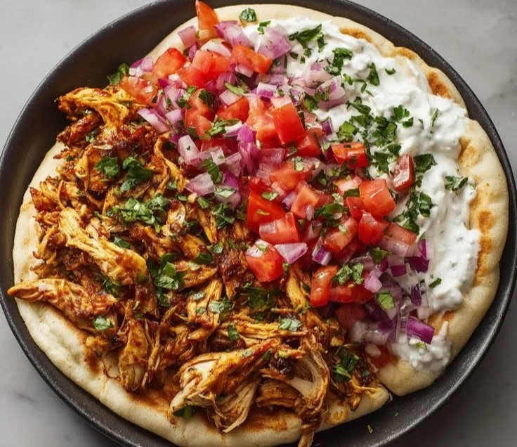 Bowl of slow cooker spiced chicken served with vegetables and rice
