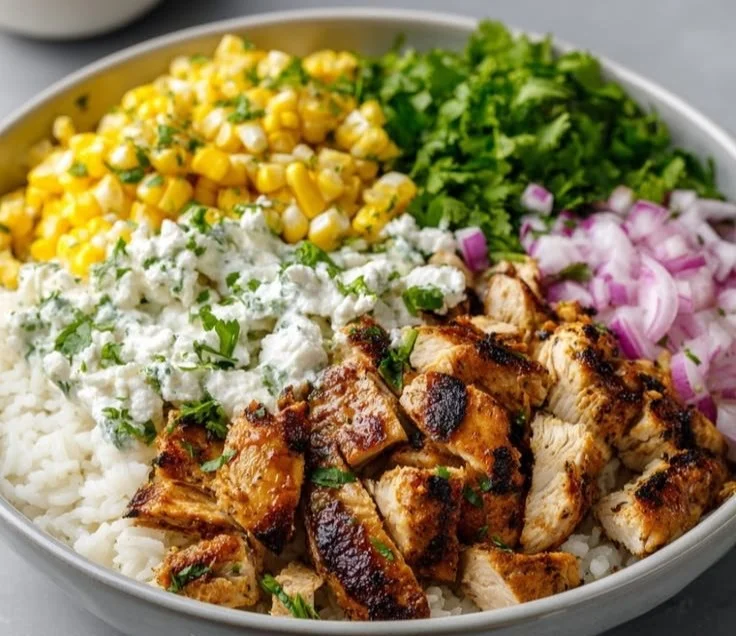 Sun-kissed grilled chicken bowl with cilantro lime rice and Mexican street corn salad