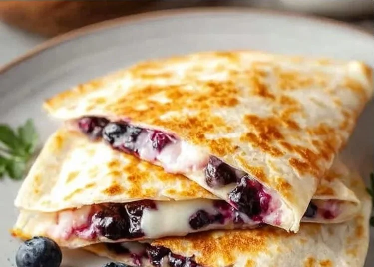 Delicious blueberry quesadilla served for breakfast with fresh blueberries