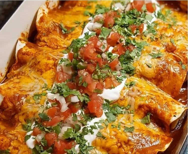Creamy high protein chicken enchiladas served on a plate with toppings.