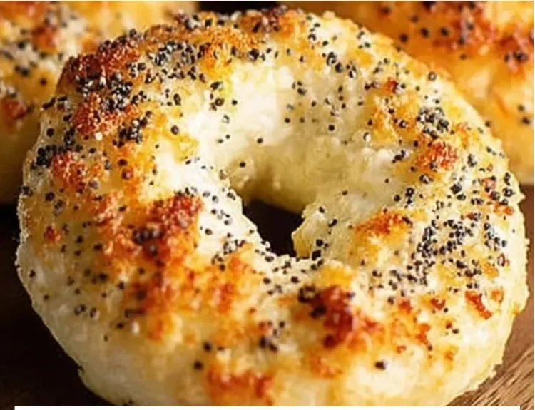 Easy no yeast cottage cheese bagels topped with herbs on a wooden board