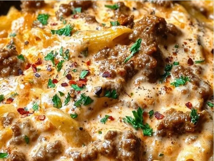 A plate of high protein pasta topped with beef and a healthy sauce