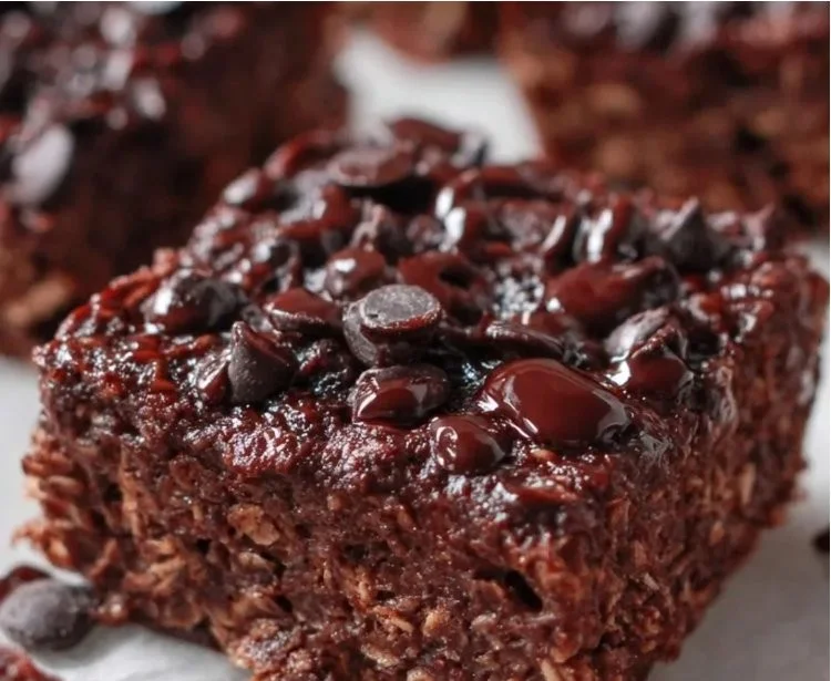 Bowl of chocolatey brownie baked oatmeal topped with fresh berries